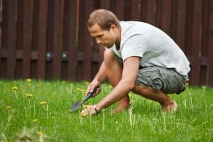 caucasian male crouching in the grass