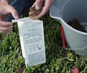 soil sample bag with a person placing soil in it